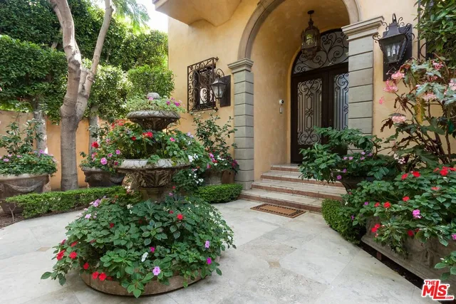 a front view of a house with a yard and flowers