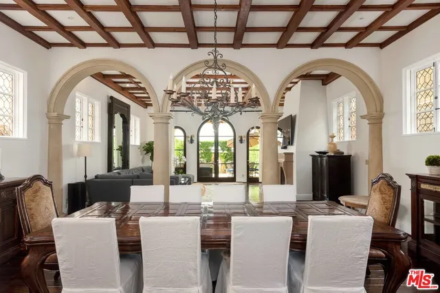 a living room with couches a table and chairs