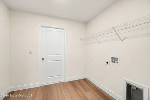 a view of a room with wooden floor