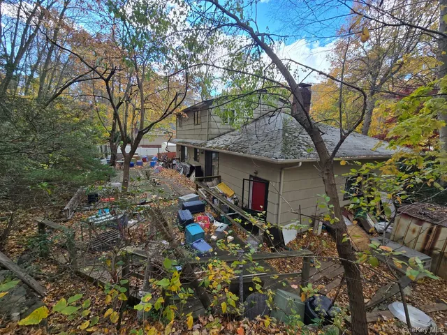 a view of a house with a tree and a yard