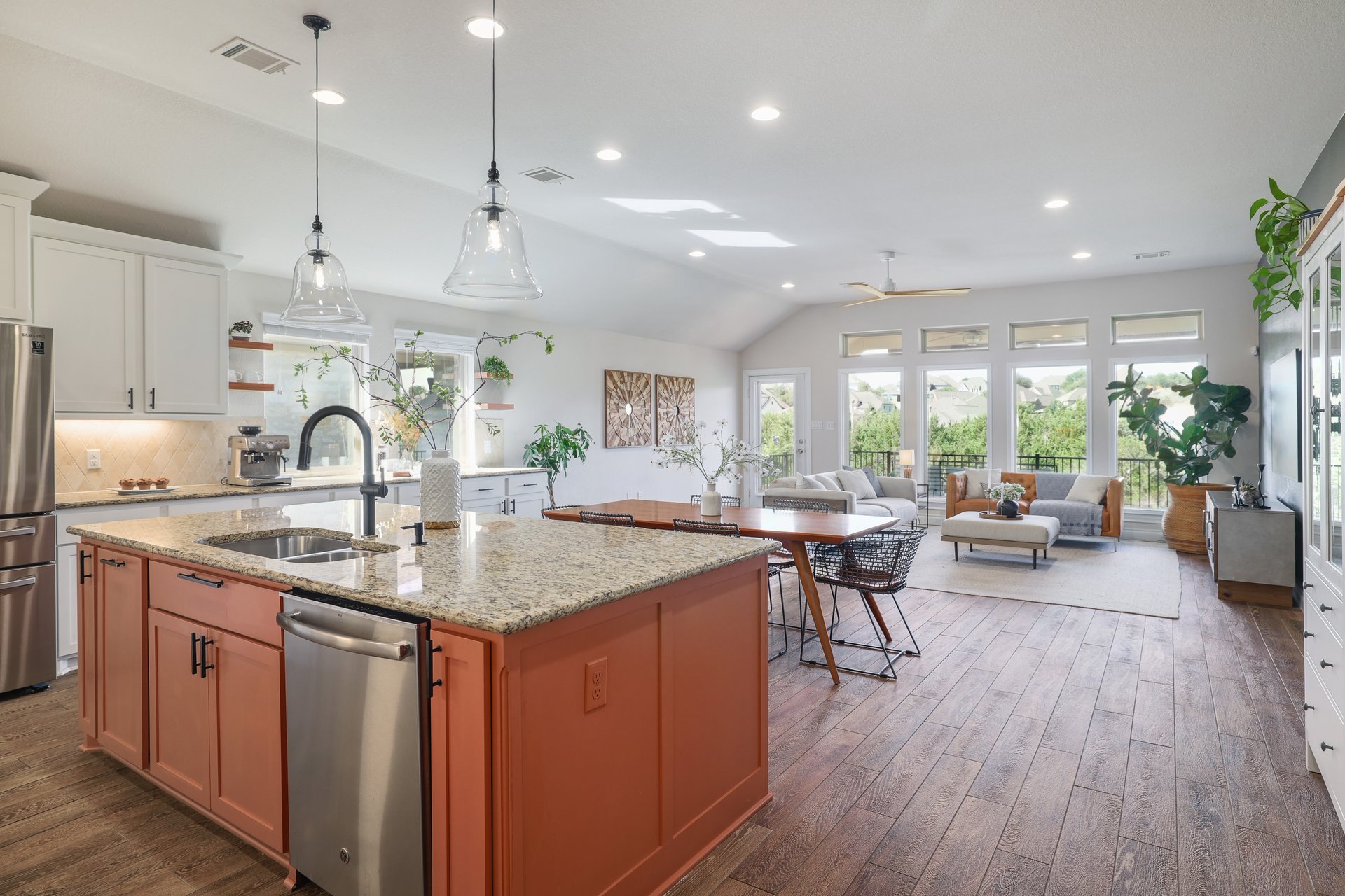 173 Santa Maria Street Georgetown, TX 78628 - Photo 8 of 39 Open-concept living space featuring a central kitchen island with a granite countertop, stainless steel appliances, and pendant lighting