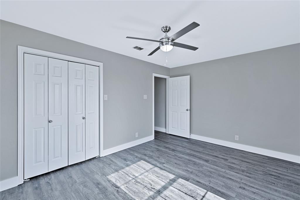 566 McCraw Lane Denison, TX 75021 - Photo 16 of 25 a view of an empty room with wooden floor and a ceiling fan