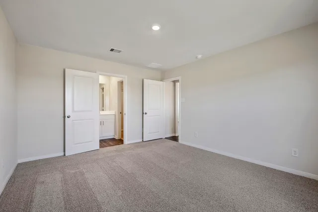 a kitchen with stainless steel appliances granite countertop a refrigerator a stove top oven a sink and dishwasher