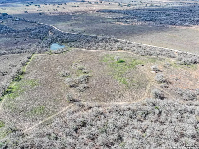 a view of a dirt yard with a lake view