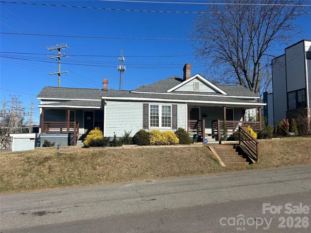 a view of a house with a porch and sitting area