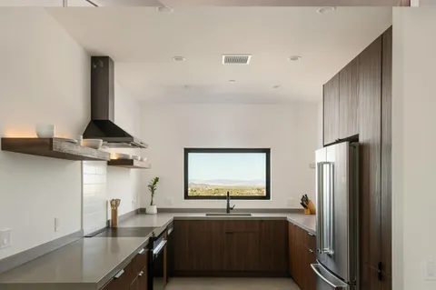 a kitchen with stainless steel appliances a sink a stove and a refrigerator