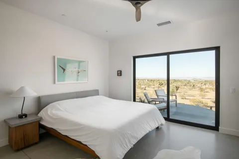 a bedroom with a large bed and a large window