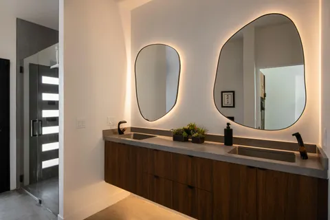 a bathroom with a double vanity sink and a mirror