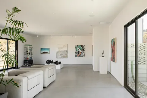 a spacious bedroom with a balcony a bed and a couch