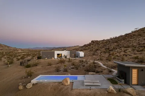 a view of a dry yard with wooden fence
