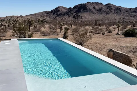 a view of house with roof deck and seating space