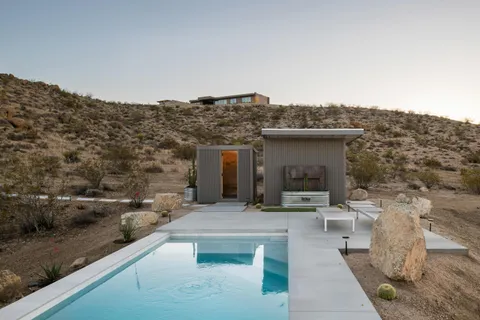 a view of a mountain with the back yard