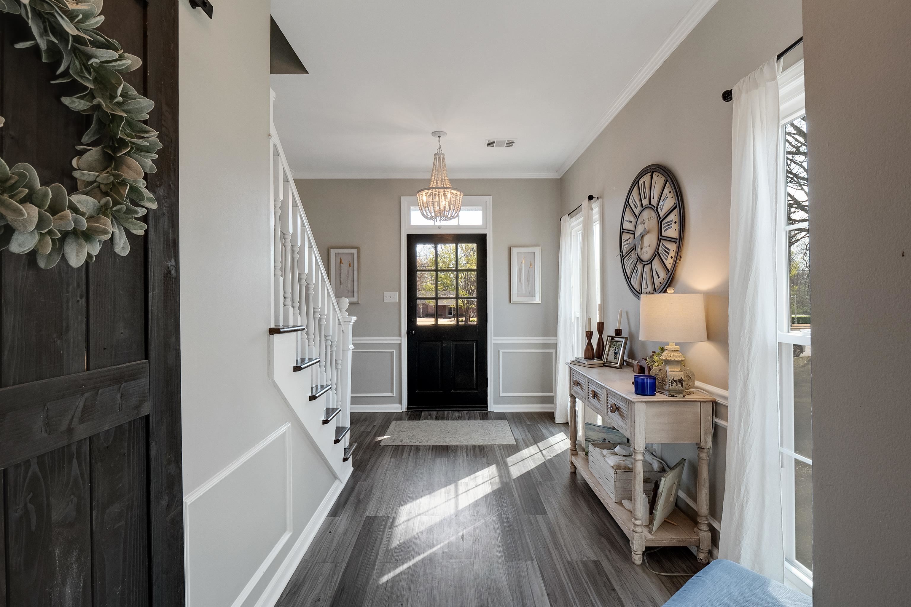 867 South Collierville Arlington Road Collierville, TN 38017 - Photo 11 of 35 Entryway featuring dark hardwood / wood-style flooring, crown molding, and a notable chandelier