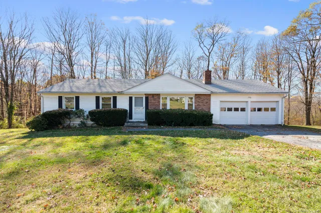 a view of a house with swimming pool and a chairs