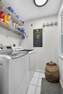 a kitchen with stainless steel appliances granite countertop a sink stove a refrigerator cabinets a dining table and chairs with wooden floor