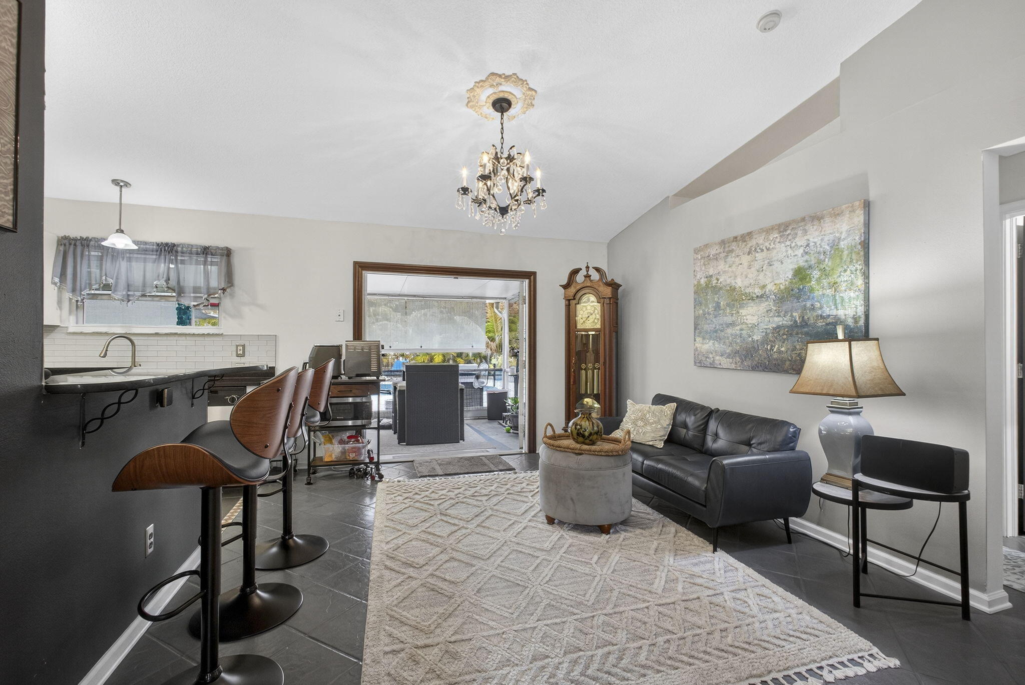 15773 85th Road North Loxahatchee, FL 33470 - Photo 17 of 75 a living room with furniture a rug a lamp and a large window