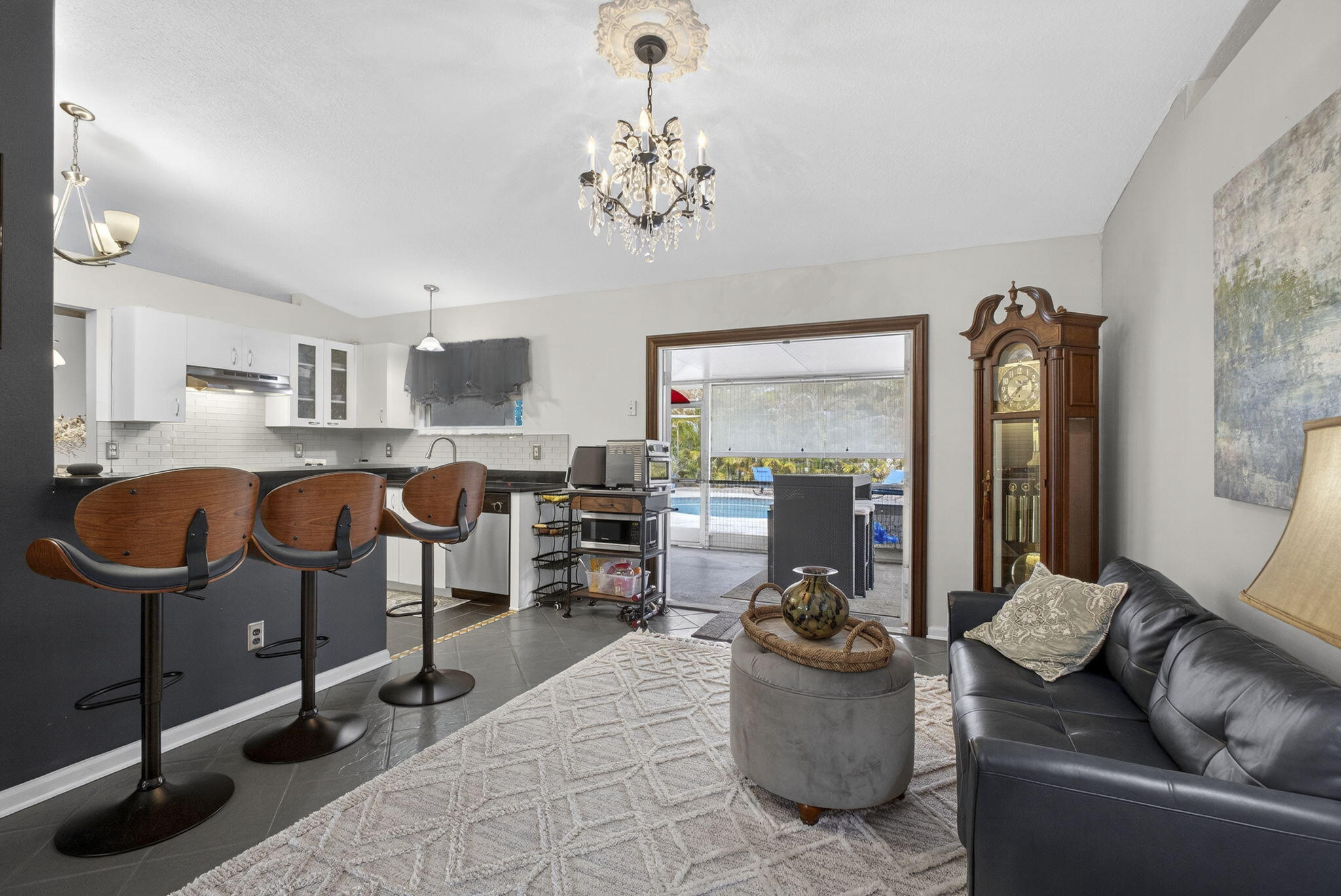 15773 85th Road North Loxahatchee, FL 33470 - Photo 18 of 75 a living room with furniture and a chandelier