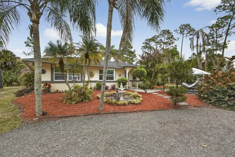 a view of a house with a patio and a yard