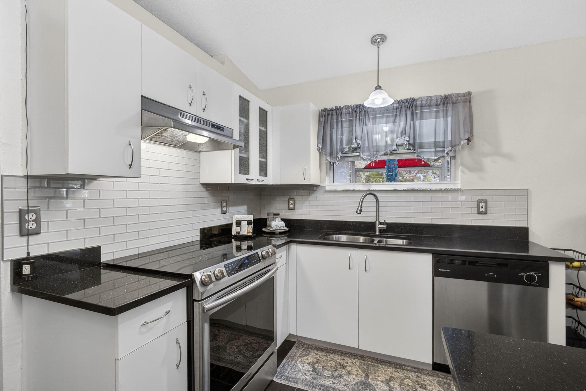 15773 85th Road North Loxahatchee, FL 33470 - Photo 23 of 75 a kitchen with stainless steel appliances granite countertop a sink stove and cabinets