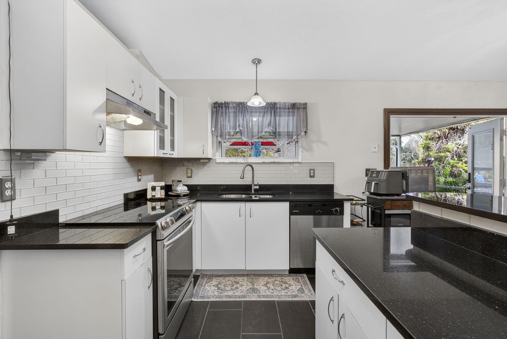 15773 85th Road North Loxahatchee, FL 33470 - Photo 24 of 75 a kitchen with a sink stove top oven and cabinets