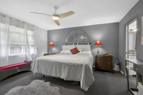 a bedroom with a bed and a chair