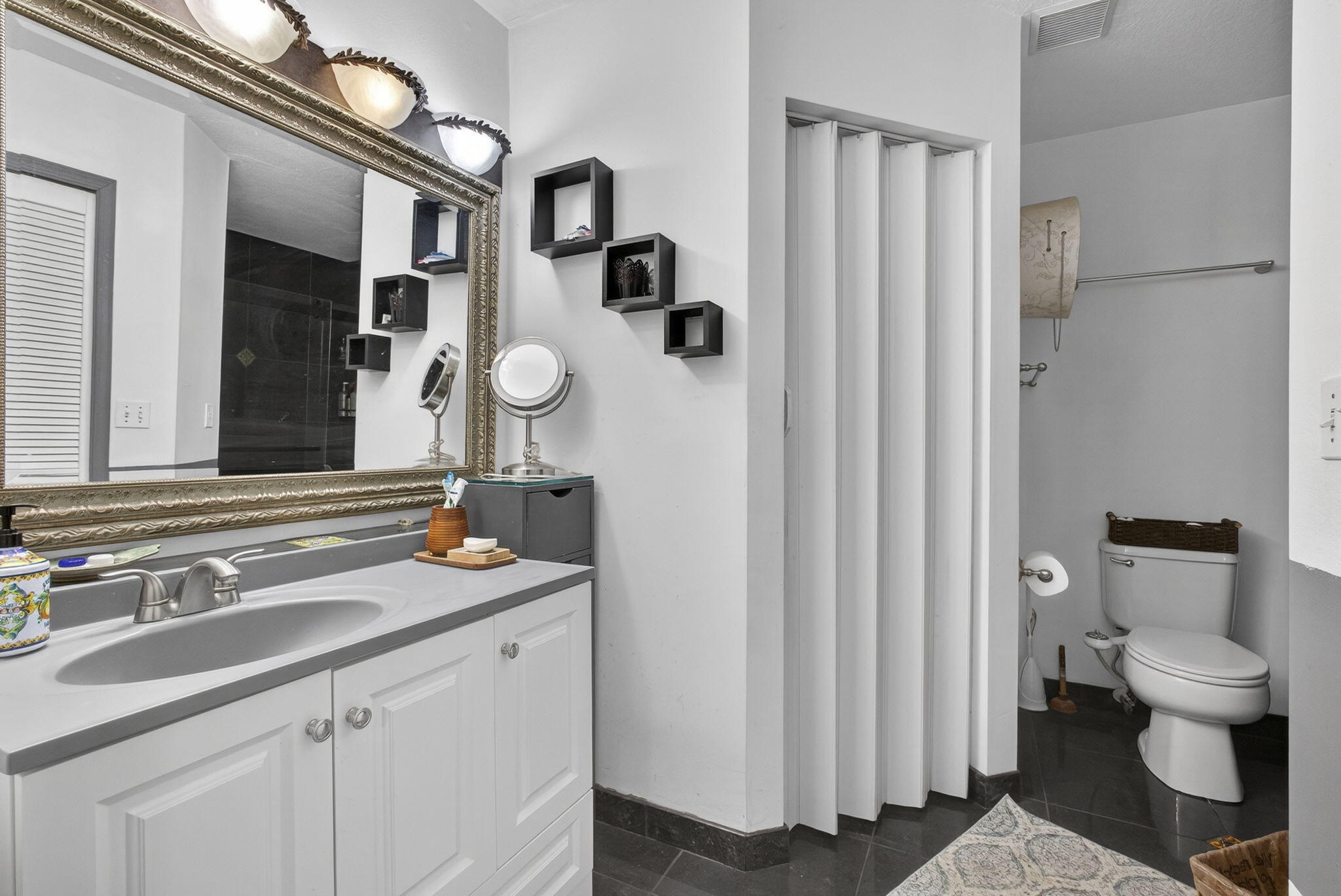 15773 85th Road North Loxahatchee, FL 33470 - Photo 30 of 75 a bathroom with a granite countertop sink vanity mirror and toilet