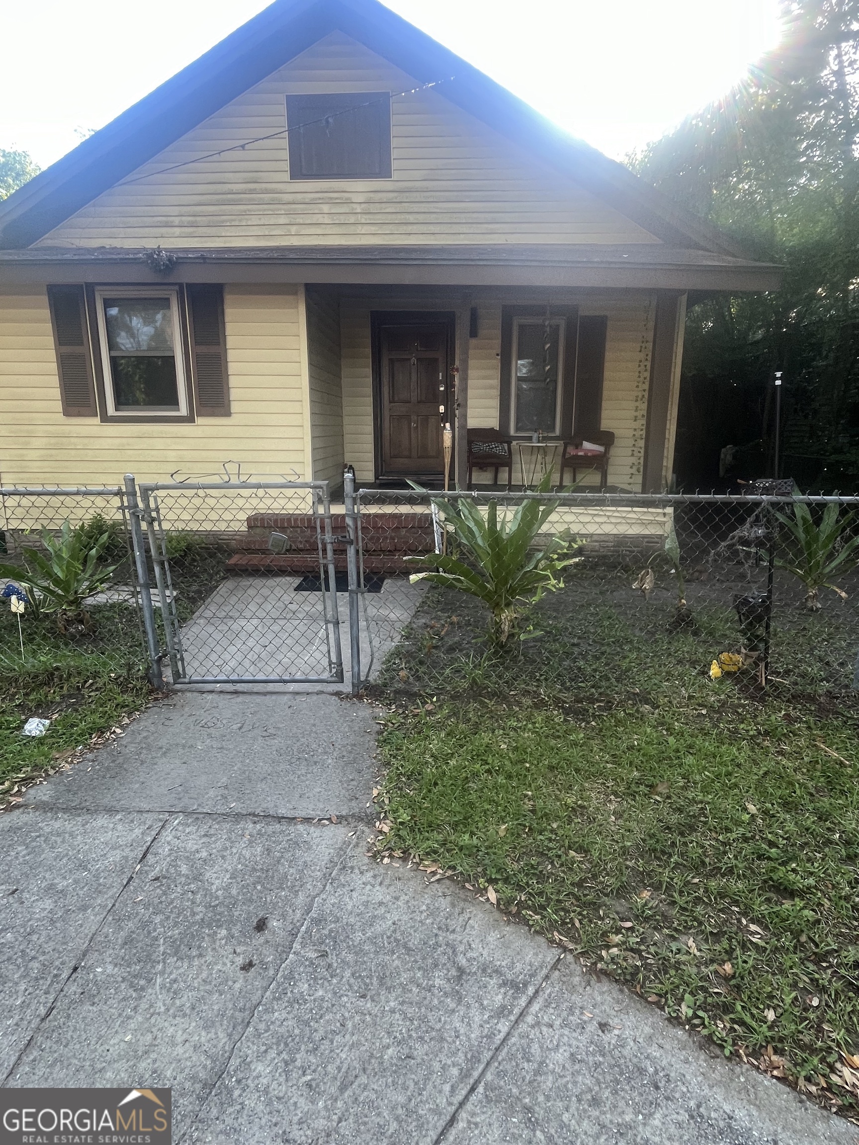 a backyard of a house with yard and outdoor seating