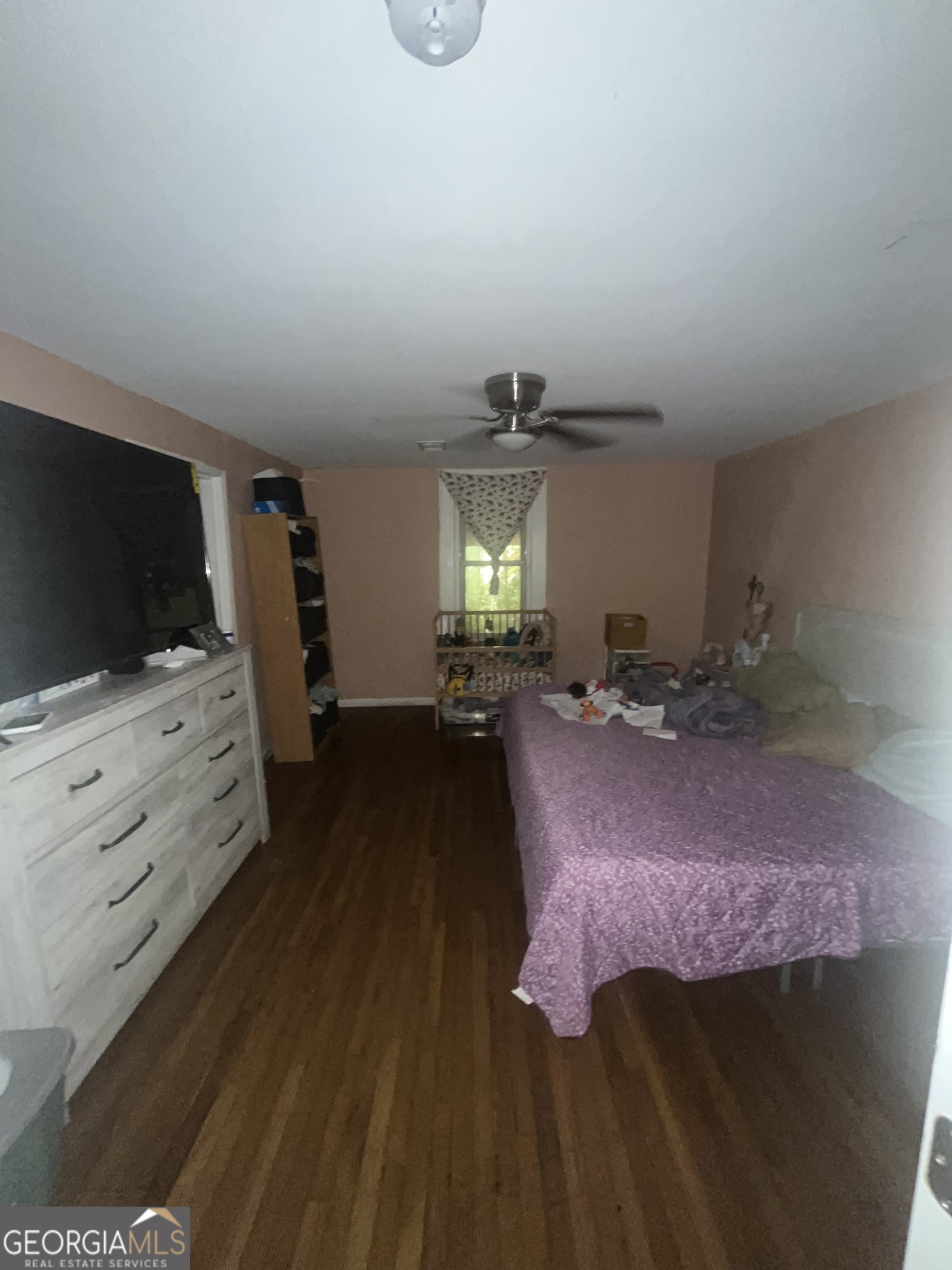 1621 Lee Street Brunswick, GA 31520 - Photo 11 of 14 a bed room with furniture and a flat screen tv