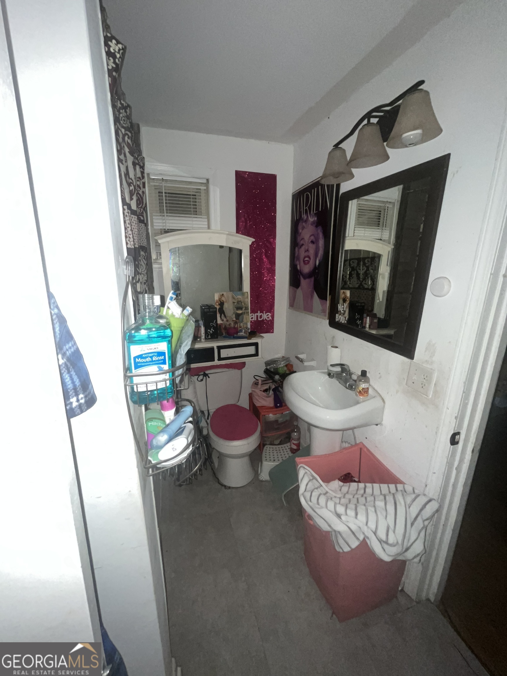 1621 Lee Street Brunswick, GA 31520 - Photo 13 of 14 a room with wooden cabinets and clock on the wall