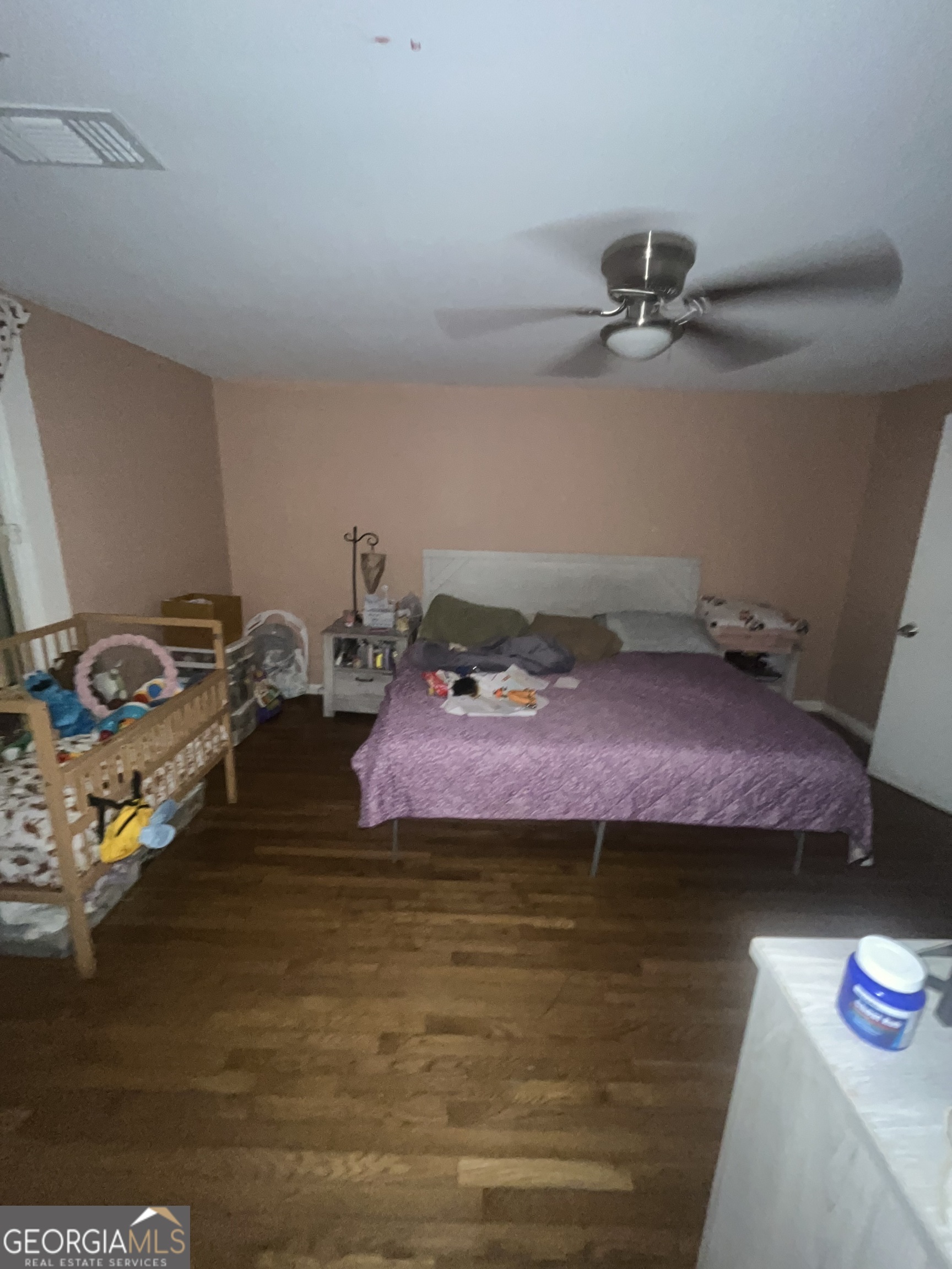 1621 Lee Street Brunswick, GA 31520 - Photo 3 of 14 a bedroom with a bed and a chandelier