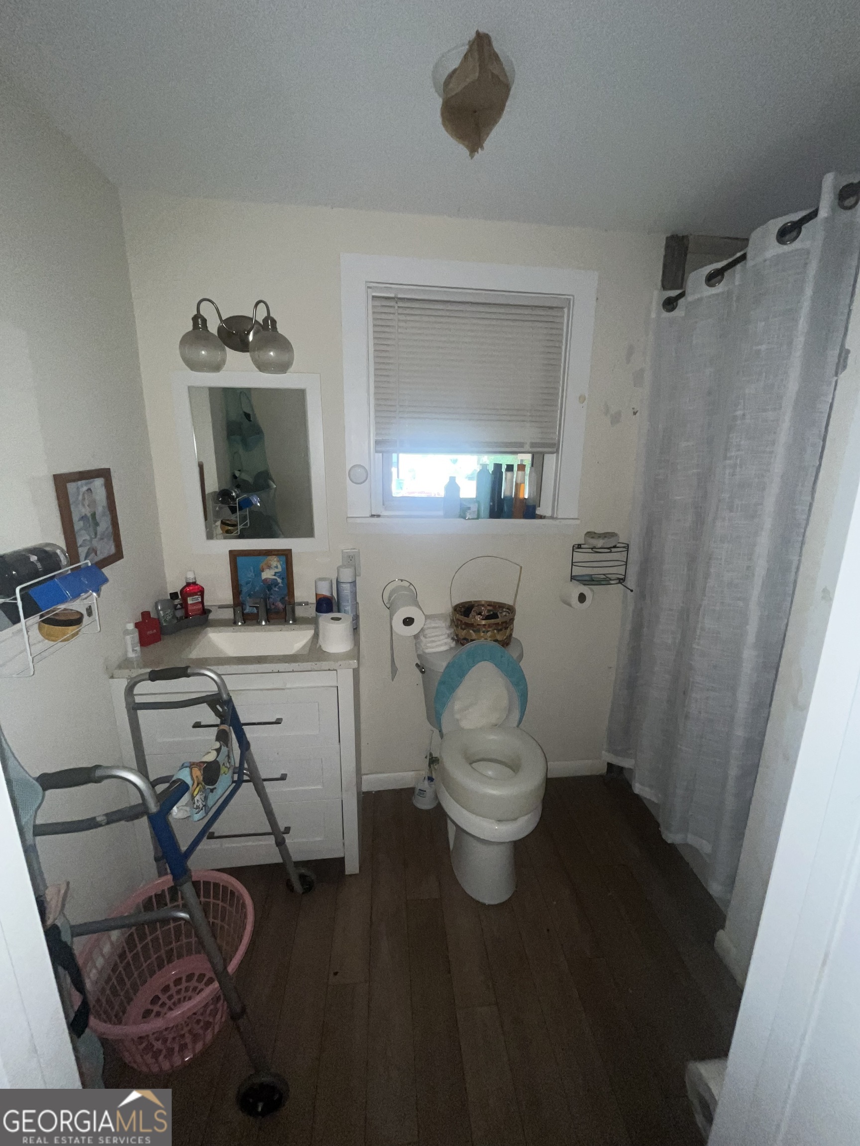 1621 Lee Street Brunswick, GA 31520 - Photo 8 of 14 a view of a bathroom with a sink and mirror