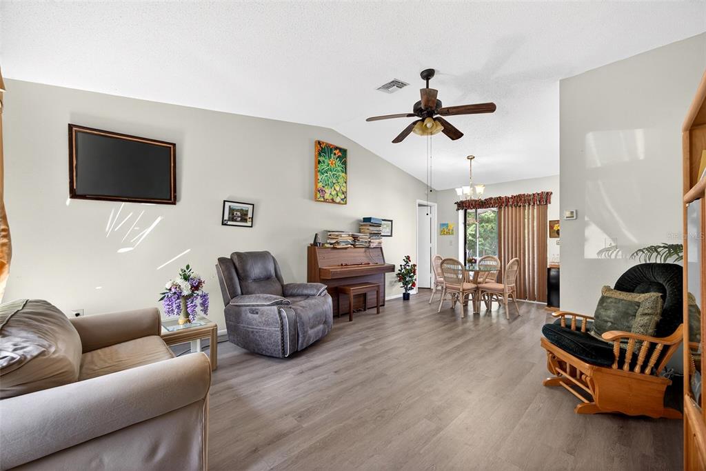 464 Coronado Road Venice, FL 34293 - Photo 3 of 28 a living room with furniture a fireplace and a flat screen tv