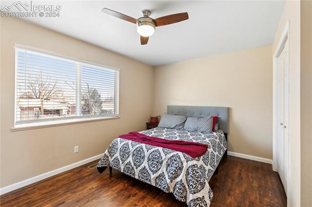 14 Duncan Road Pueblo, CO 81001 - Photo 9 of 26 Bedroom with brilliant natural light, dark hardwood flooring, and ceiling fan. bedroom #1