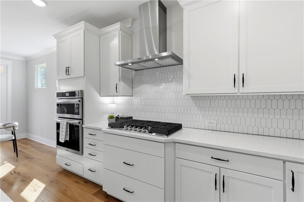 203 Sunshower Ridge Canton, GA 30114 - Photo 15 of 58 a kitchen with white cabinets and appliances