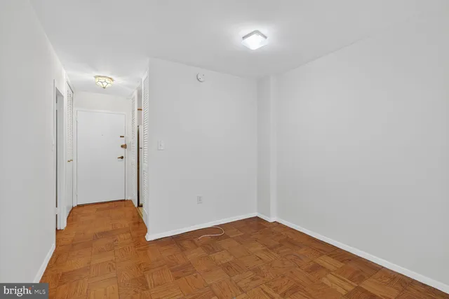 a hallway with windows and chandelier