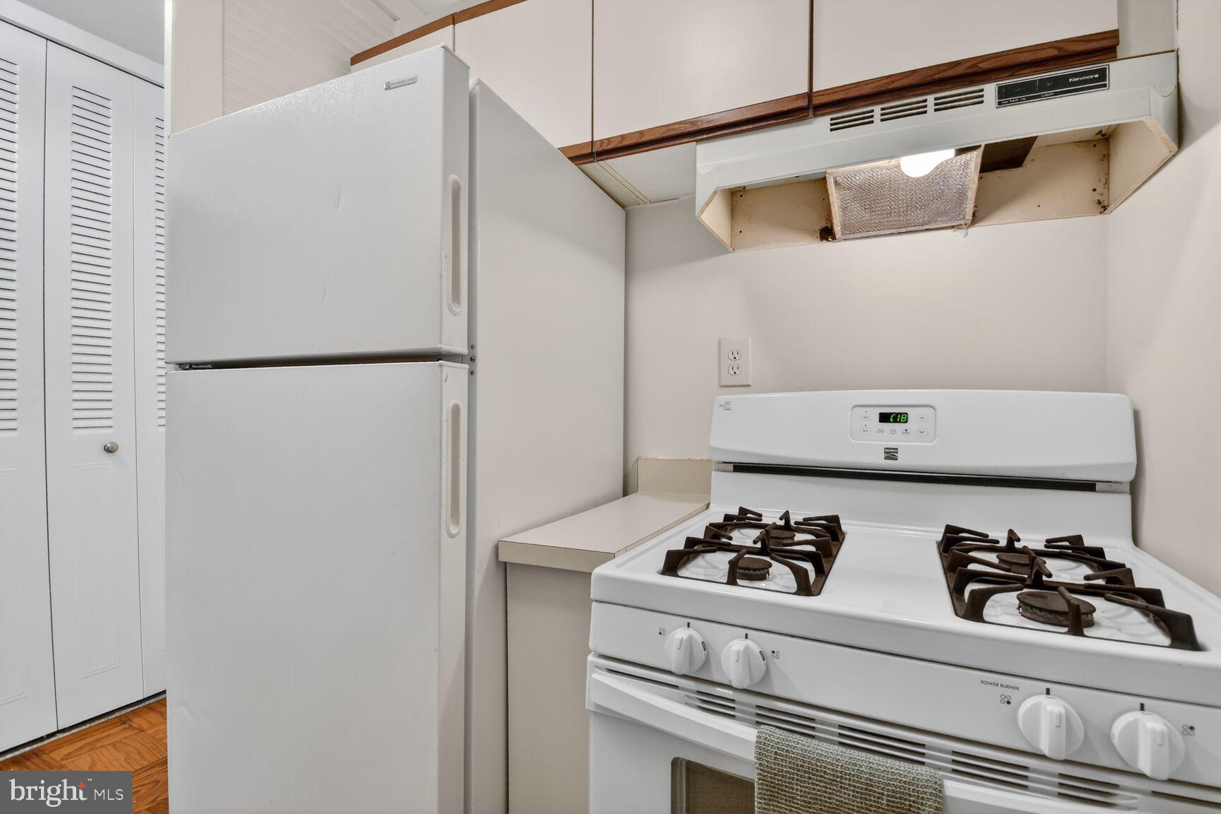 2030 F Street Northwest, Unit 411 Washington, DC 20006 - Photo 11 of 22 a kitchen with a refrigerator and a stove