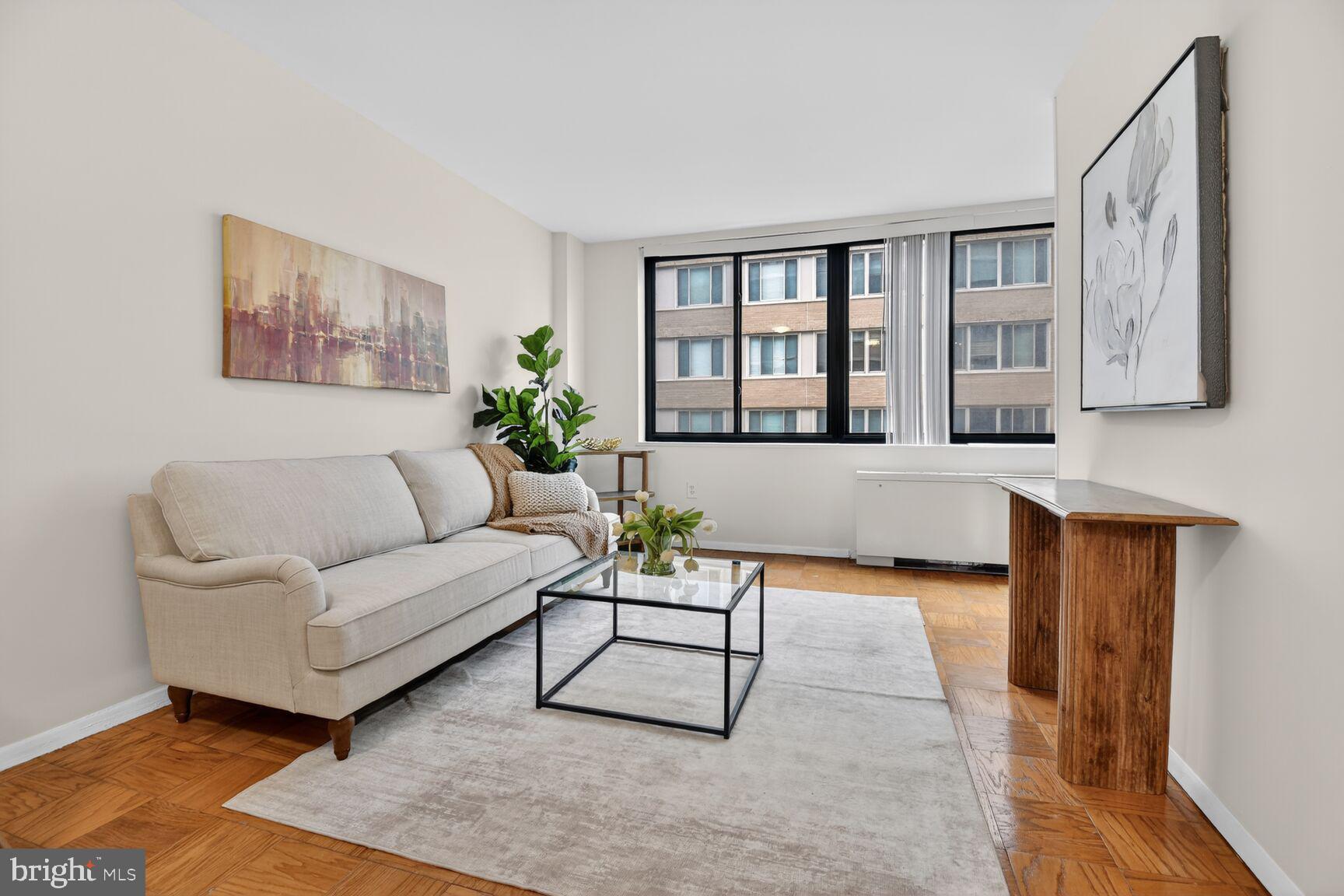 2030 F Street Northwest, Unit 411 Washington, DC 20006 - Photo 12 of 22 a living room with furniture and a rug