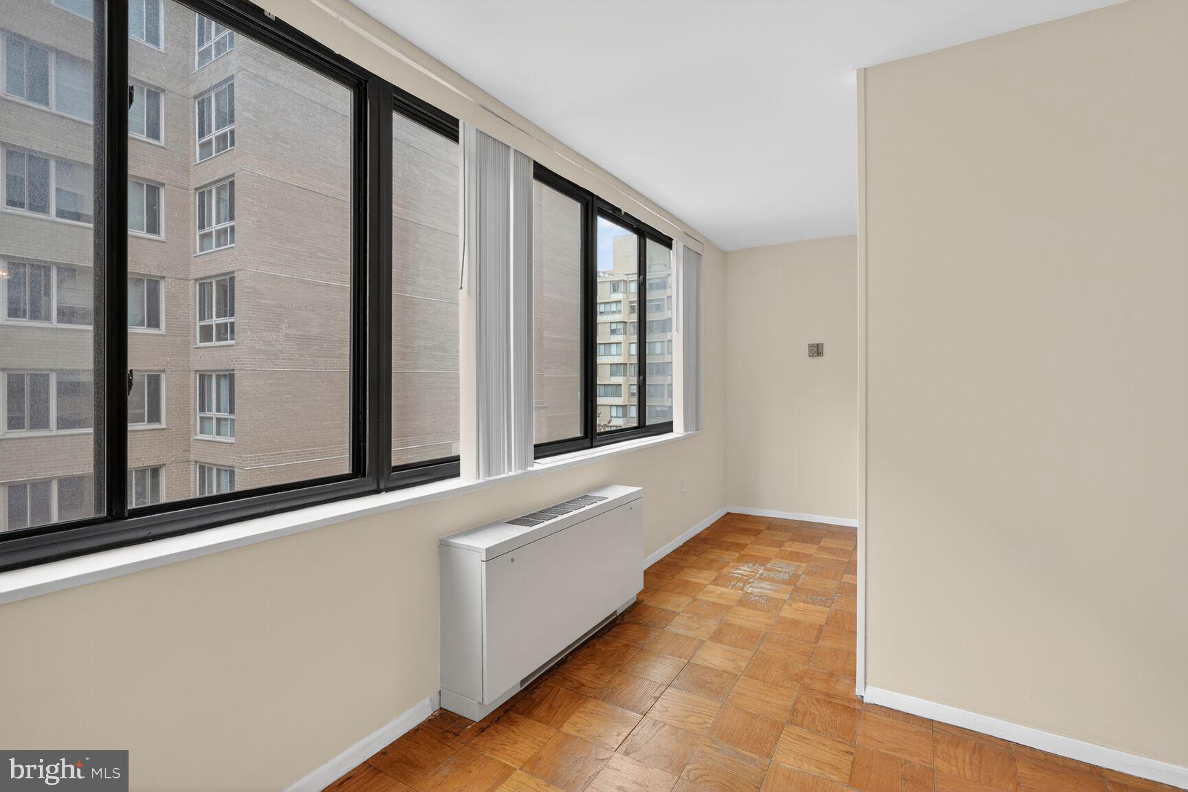 2030 F Street Northwest, Unit 411 Washington, DC 20006 - Photo 13 of 20 a hallway with windows and chandelier