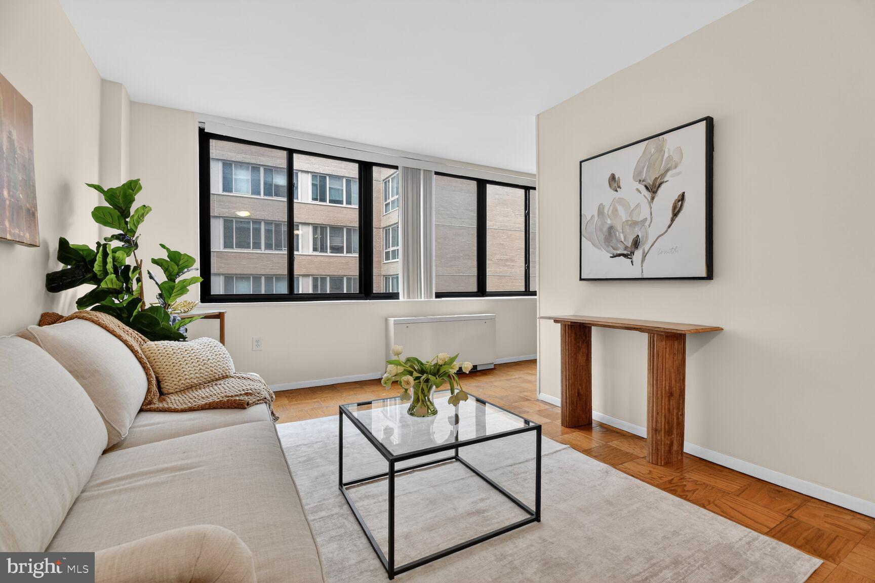 2030 F Street Northwest, Unit 411 Washington, DC 20006 - Photo 13 of 22 a living room with furniture and a potted plant