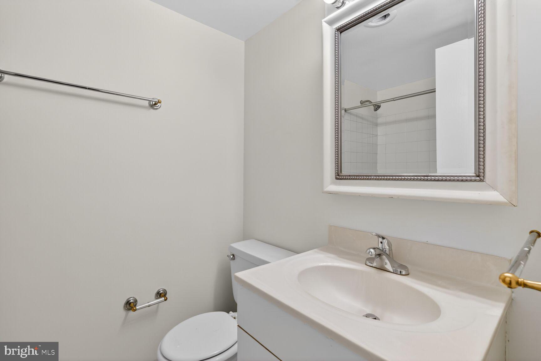 2030 F Street Northwest, Unit 411 Washington, DC 20006 - Photo 17 of 20 a bathroom with a sink toilet and mirror