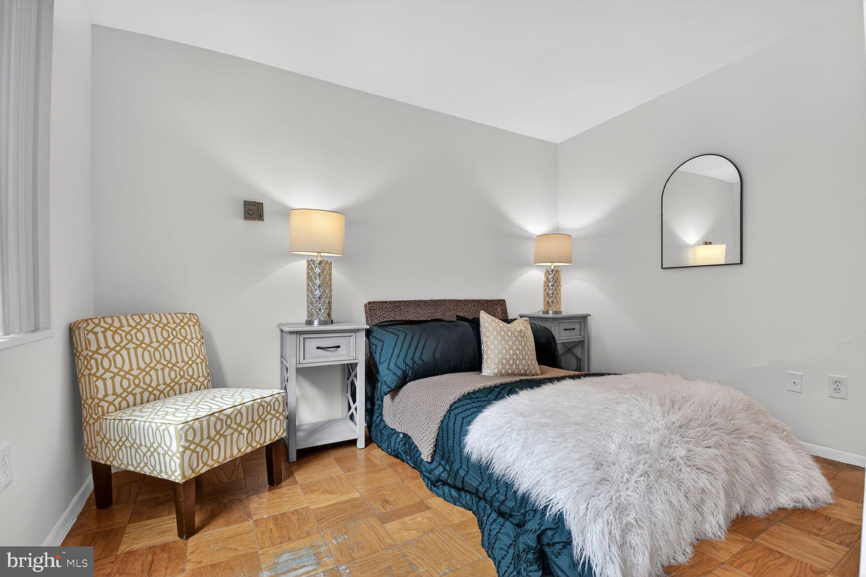 2030 F Street Northwest, Unit 411 Washington, DC 20006 - Photo 18 of 22 a bed room with two bed and a chair