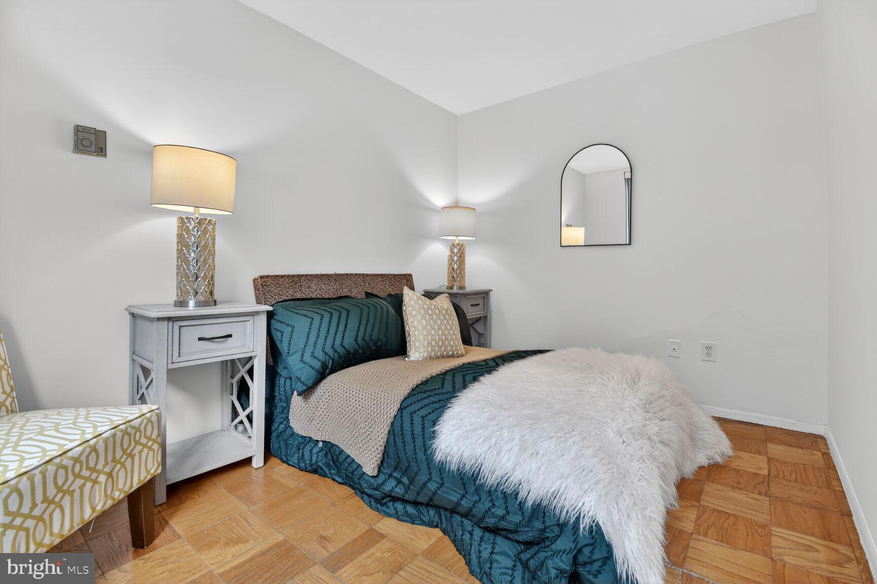 2030 F Street Northwest, Unit 411 Washington, DC 20006 - Photo 19 of 22 a bedroom with a bed and a lamp