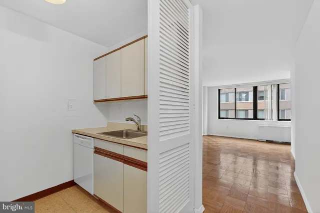 a kitchen with a sink and cabinets