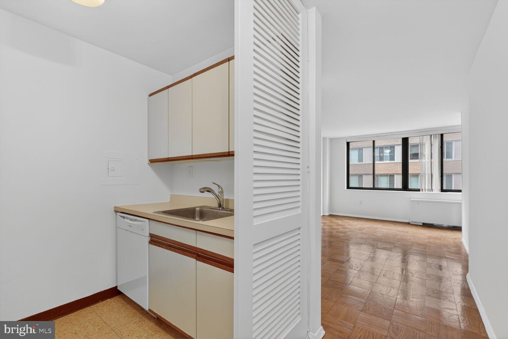 2030 F Street Northwest, Unit 411 Washington, DC 20006 - Photo 4 of 20 a kitchen with a sink and cabinets