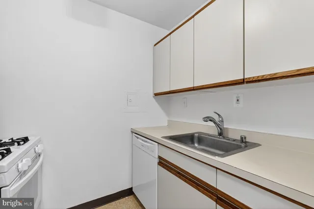 a kitchen with sink and cabinets