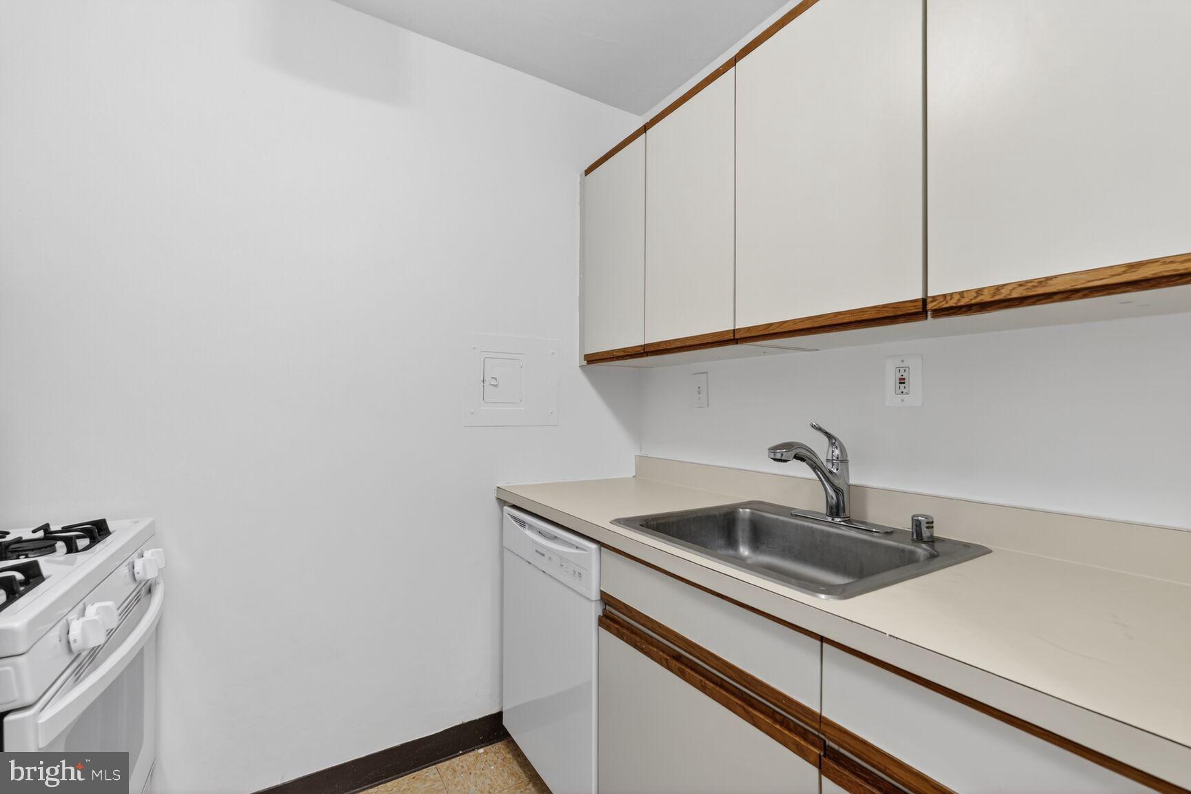 2030 F Street Northwest, Unit 411 Washington, DC 20006 - Photo 5 of 20 a kitchen with a sink and cabinets
