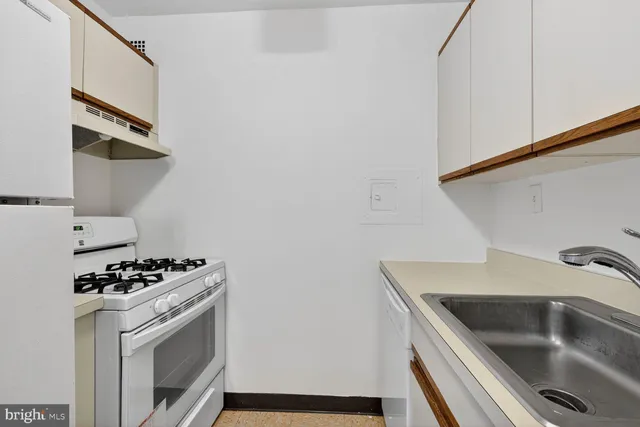 a kitchen with a sink and cabinets