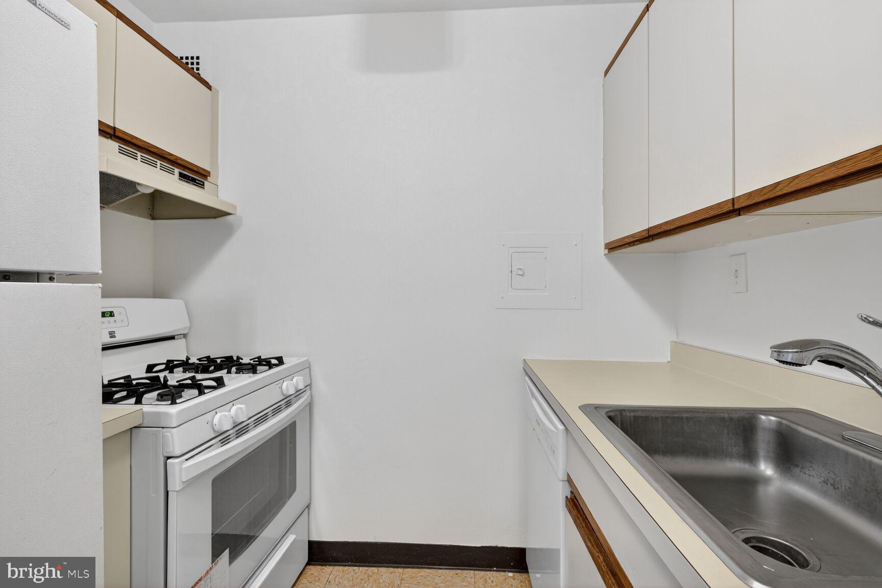 2030 F Street Northwest, Unit 411 Washington, DC 20006 - Photo 6 of 20 a kitchen with sink and cabinets