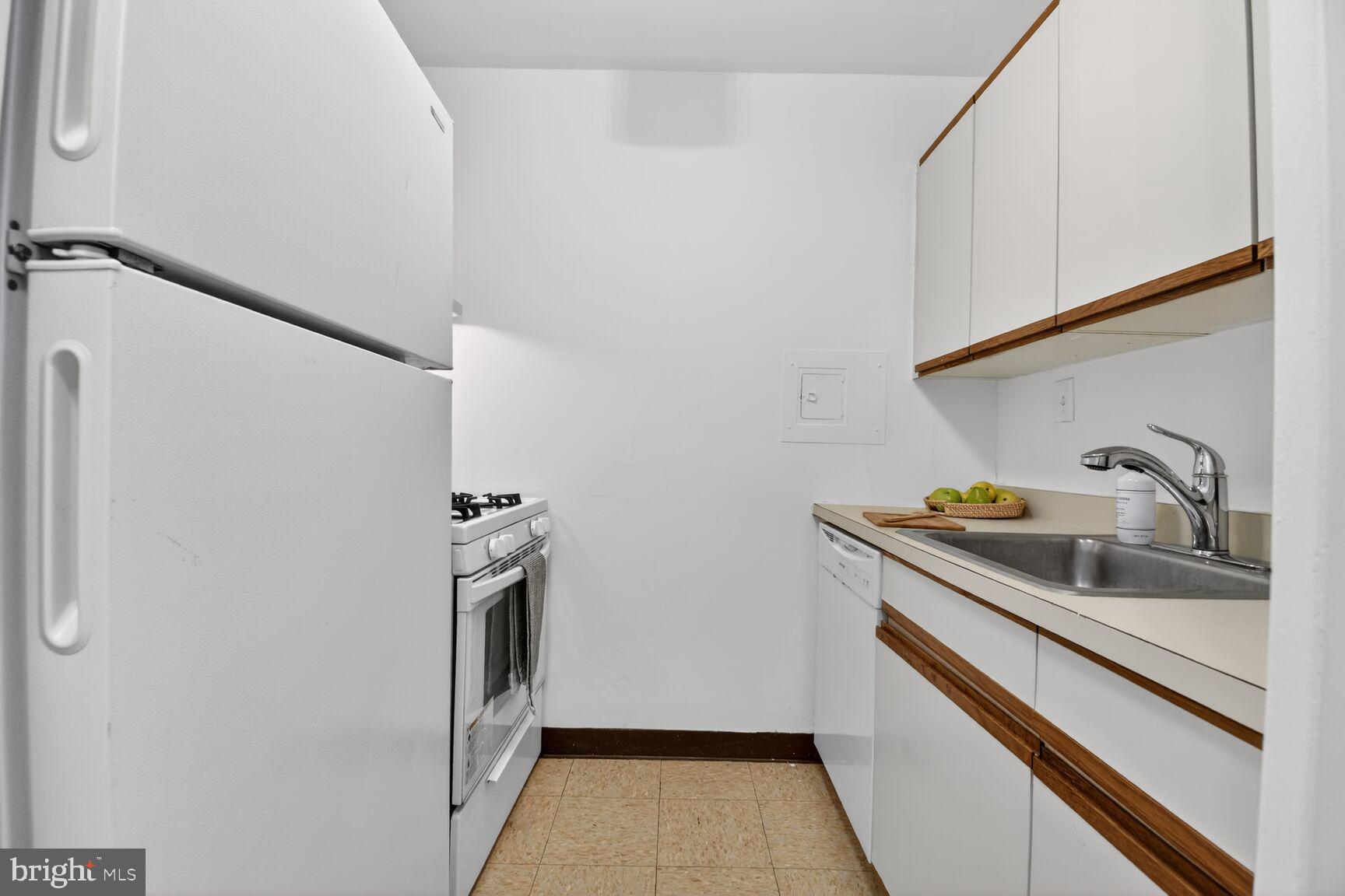 2030 F Street Northwest, Unit 411 Washington, DC 20006 - Photo 9 of 22 a kitchen with a sink and refrigerator