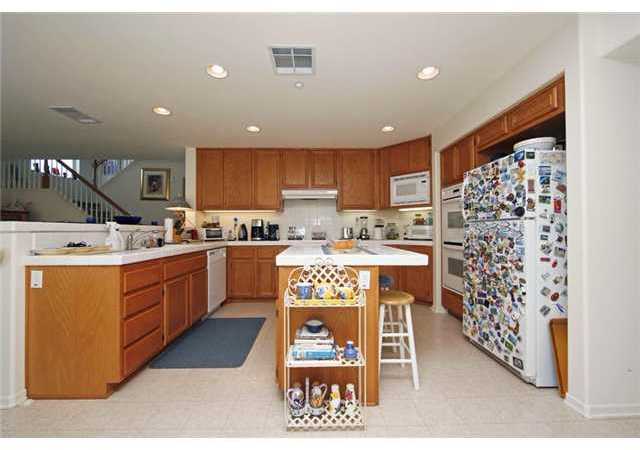 2332 Pointe Parkway Spring Valley, CA 91978 - Photo 9 of 25 Ideally designed, the kitchen is open to the family room and enjoys a center island and oodles of cabinetry!